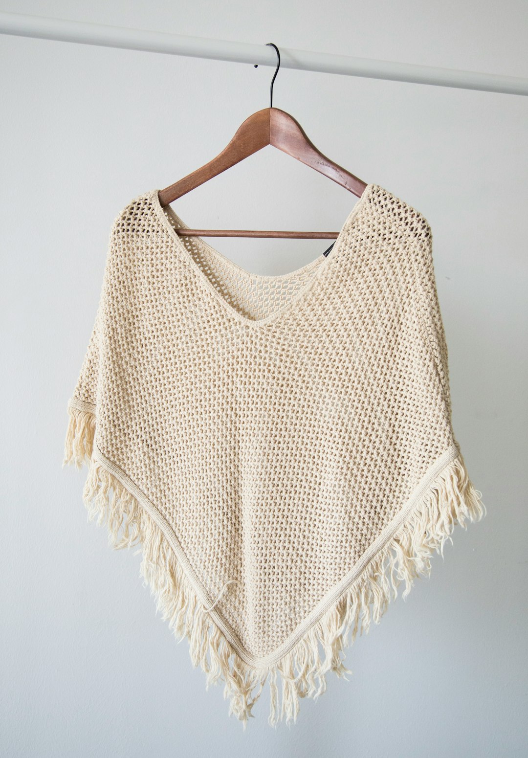 white-v-neck-shirt-on-brown-clothes-hanger-p8drpg-dulw